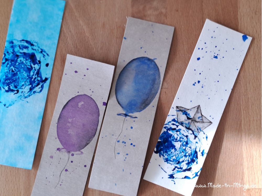 Verschiedene Motive auf Lesezeichen malen.